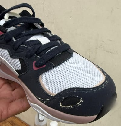 Before: white mould along the stitching and suede toe of a navy and white trainer